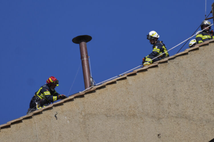 Vatican firefighters install chimney on roof of Sistine Chapel for papal election